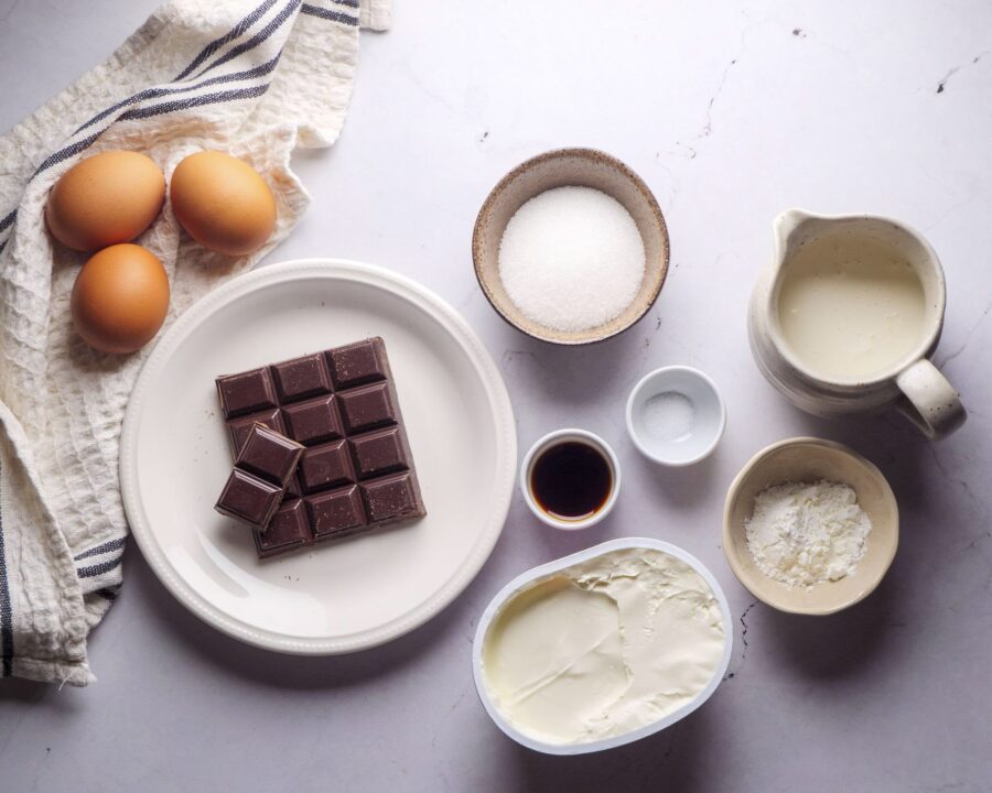 Ingredients for Iceberg Basque Cheesecake on a white kitchen counter
