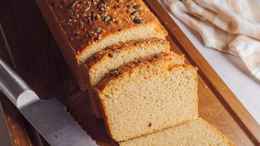 Red Lentil Bread piece on a cutting board with a knife