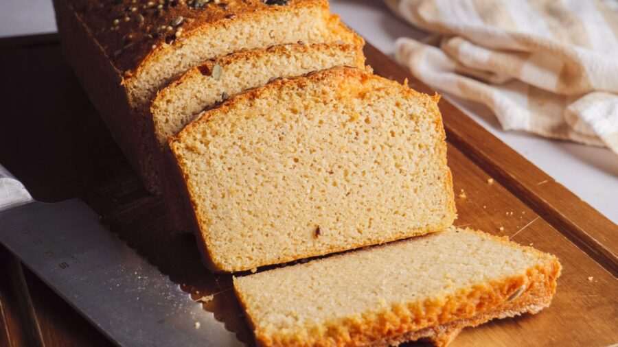 Red Lentil Bread piece on a cutting board with a knife